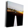 3dRose White middle line of a runway with some mountains in... - Museum Grade Canvas Wrap (cw_210682)